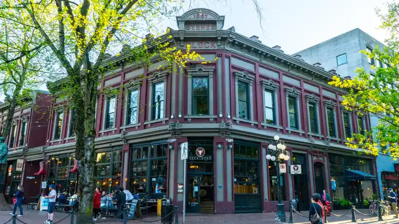 Historic Victorian brick buildings and tree-lined streetscape in Gastown Vancouver