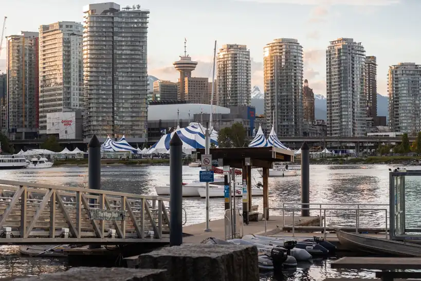 Vancouver skyline reflecting over water during golden hour