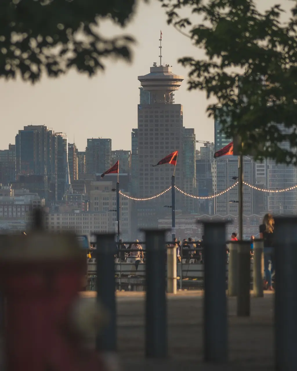 Pedestrian view across Coal Harbour toward the landmark Canada Place sails at sunset