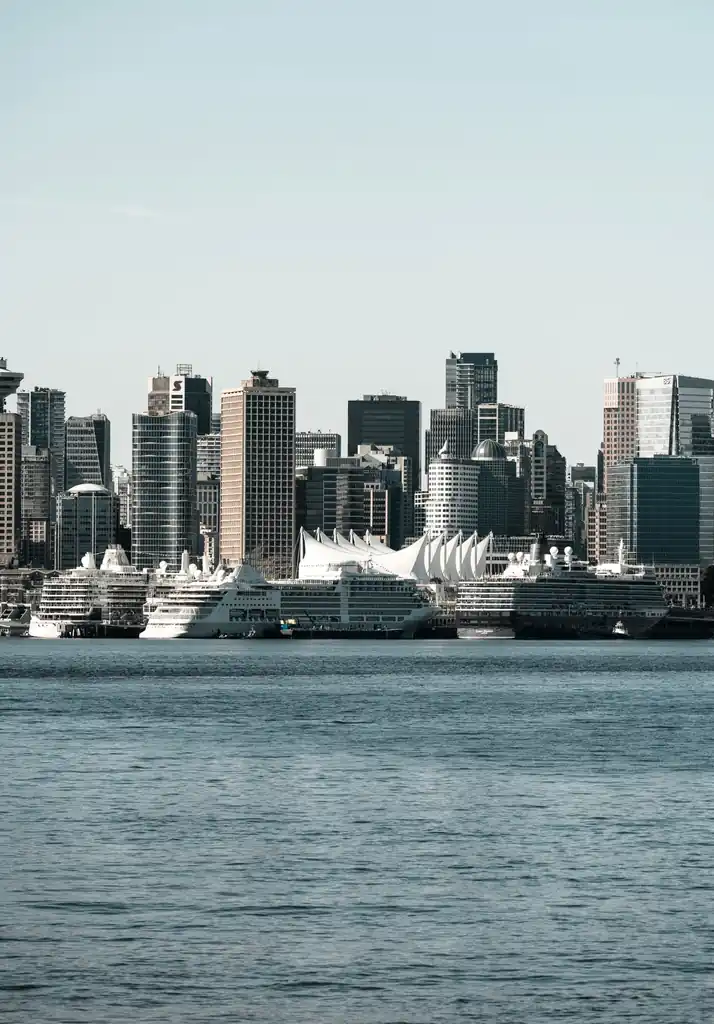 Vancouver waterfront with docked passenger liners and downtown skyline