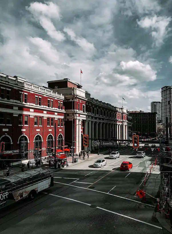 Urban streetscape in Vancouver showing historic heritage architecture under soft maritime clouds
