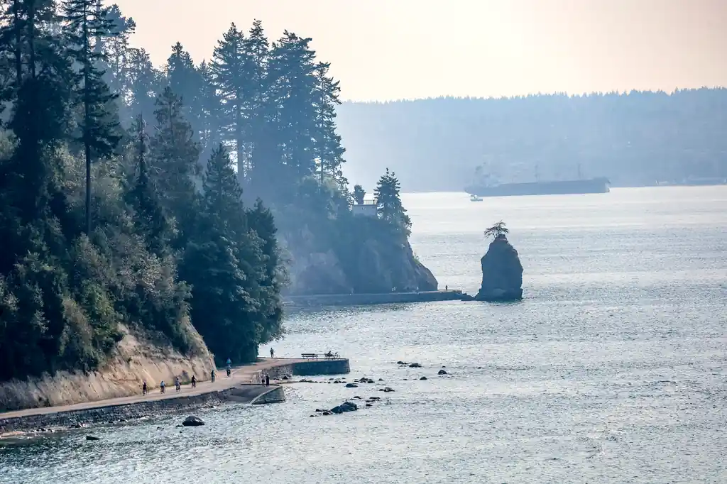 Lush evergreen coastal path and landscaped urban public space along Stanley Park