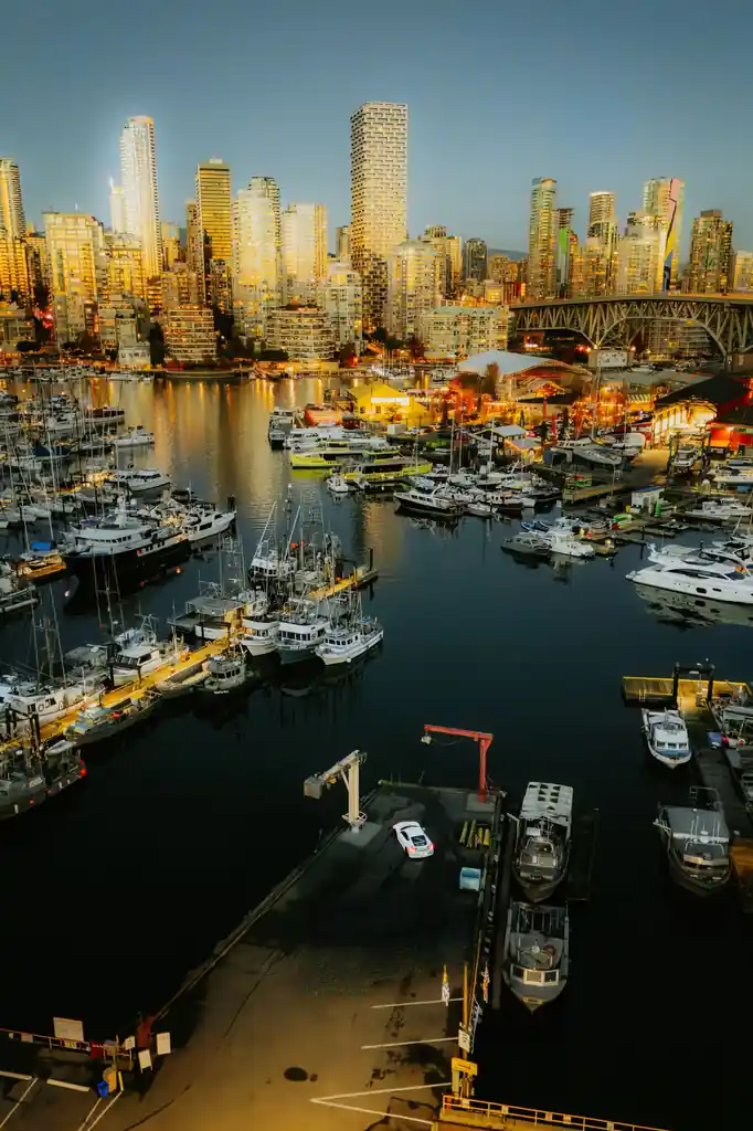 Twilight view of boats and evening cityscape in Vancouver