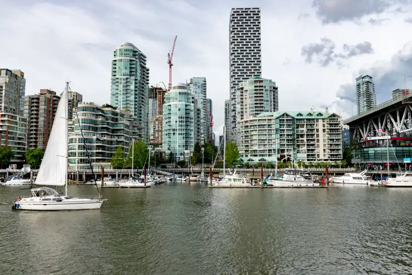 Modern skyline of Vancouver with sailboats docked at the waterfront marina
